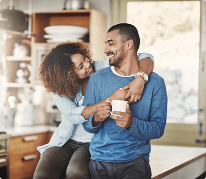 couple sitting on counter drinking coffee