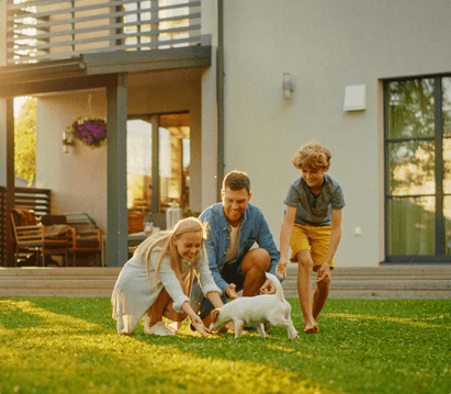 family with dog playing in yard