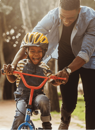 Father helping son ride a bike