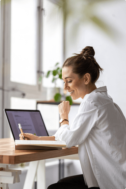 woman sitting at a table using a laptop