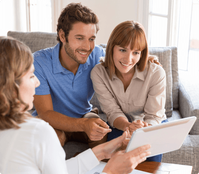 couple sitting on couch looking at their numbers