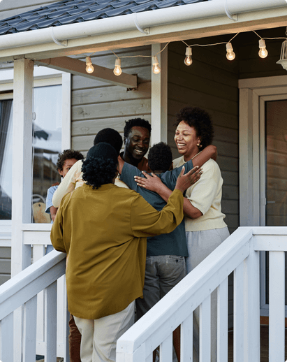 family embracing each other on the steps of their front porch