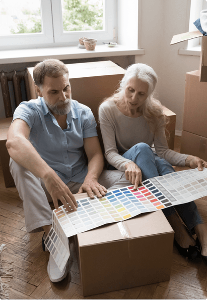 couple sitting on the floor looking at color swatches
