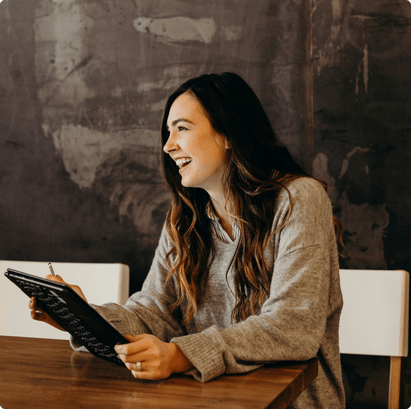 A woman sitting at a desk smiling