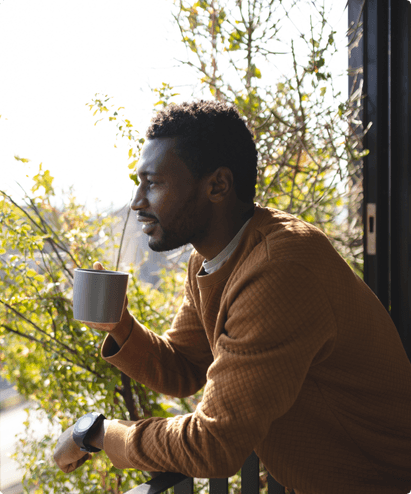 man drinking coffee while enjoying the view