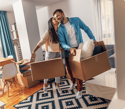 couple moving boxes into home
