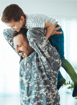 military father lifting child on his back