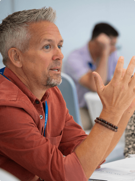 man sitting at a table having a conversation