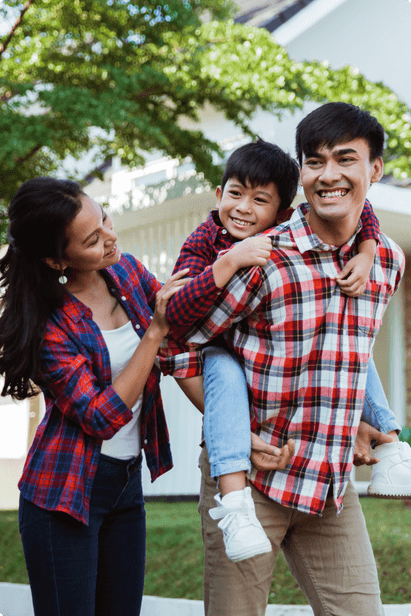 family with the father giving their son a piggyback ride