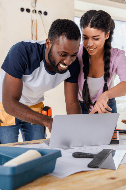 couple standing using laptop together